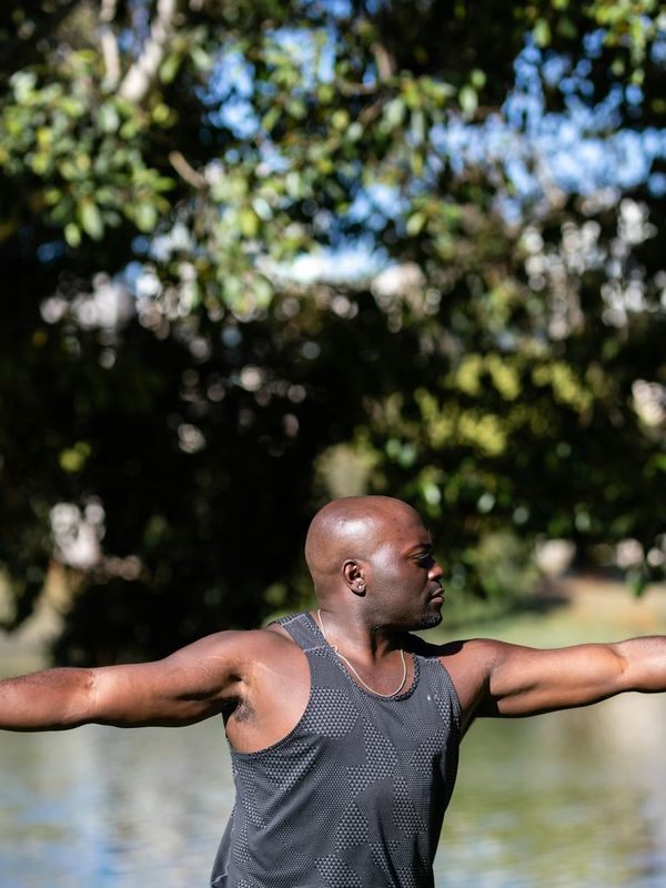 Person stretching outdoors, representing vitality and renewed energy.